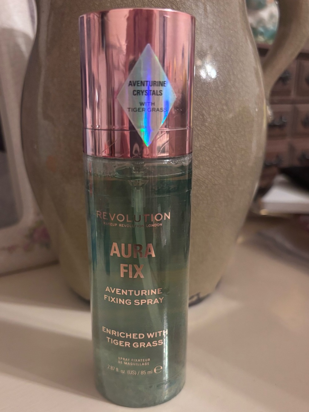 Revolution Aura Fix Aventurine Fixing Spray — Pink Cap, Green Bottle